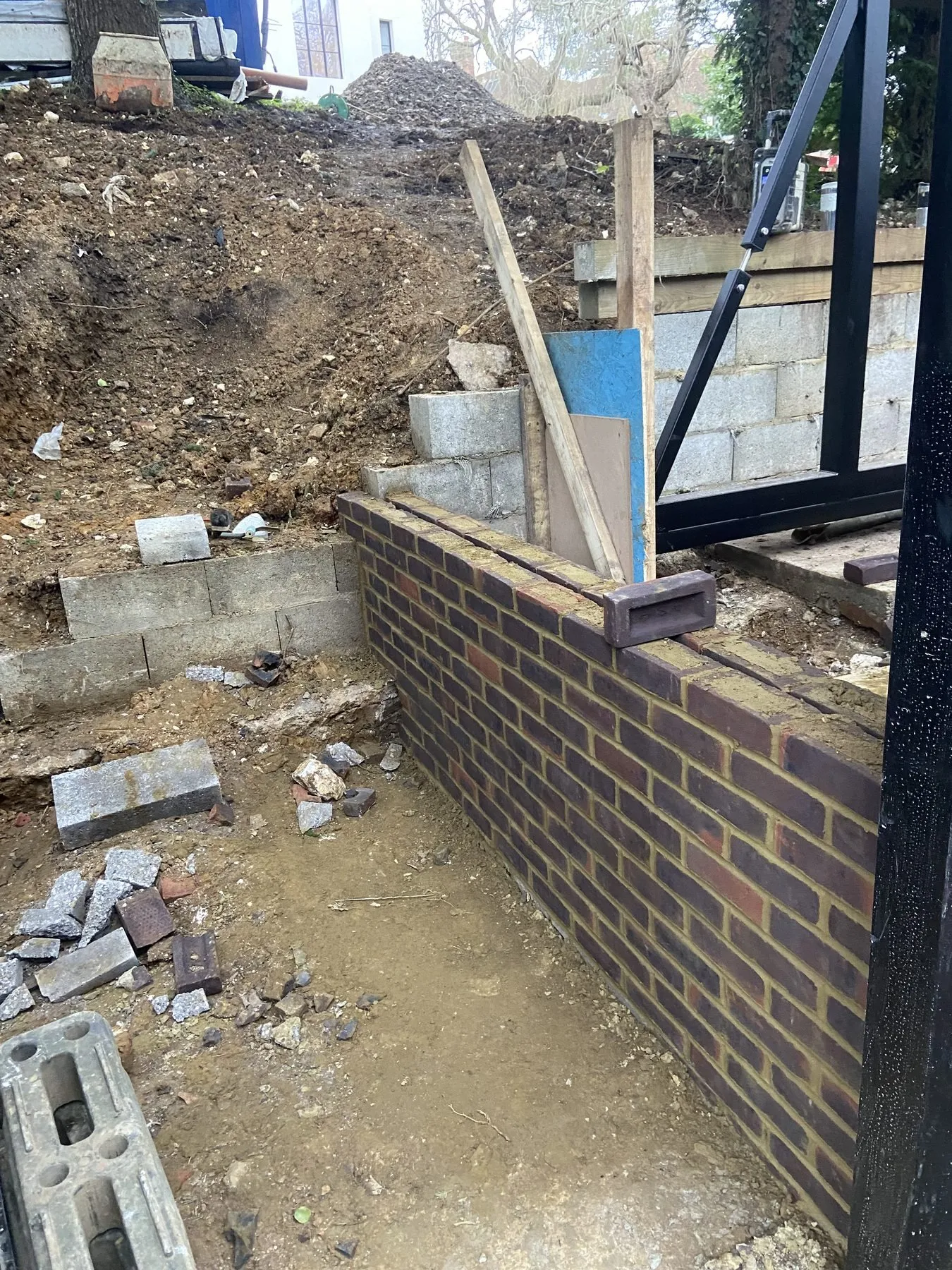 New brick wall forming the approach to a garden entrance during construction in Brighton and Hove