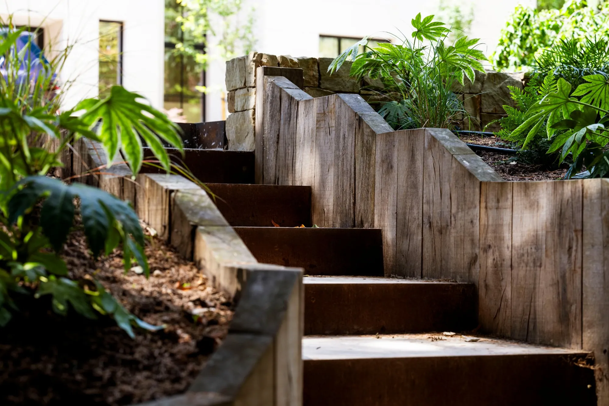 Close view of upright oak sleepers and weathering metal step risers in Brighton and Hove