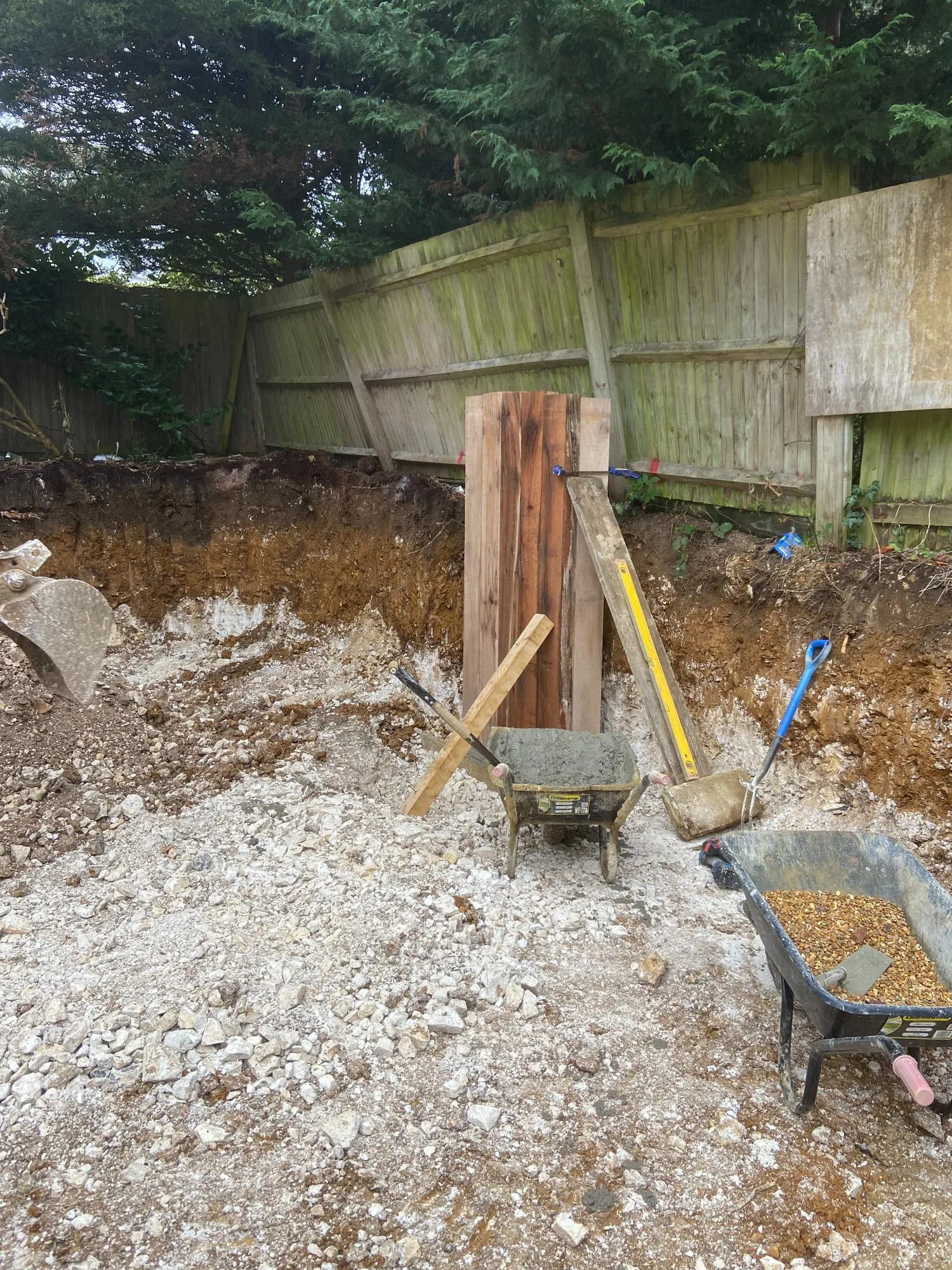 First oak sleepers being set in place during the retaining wall build in Brighton and Hove
